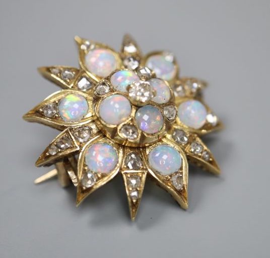 An Edwardian yellow metal, opal and diamond set flower head brooch, 25mm, gross 6.9 grams.